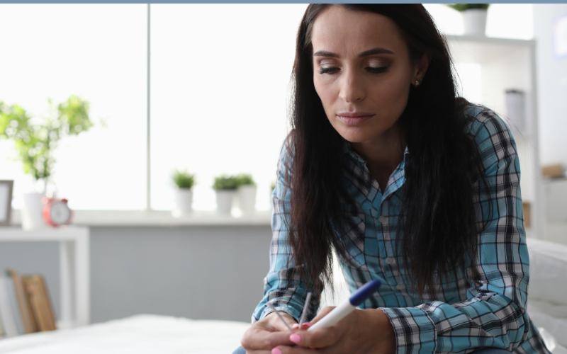 woman sitting looking down with sadness and feeling guilt